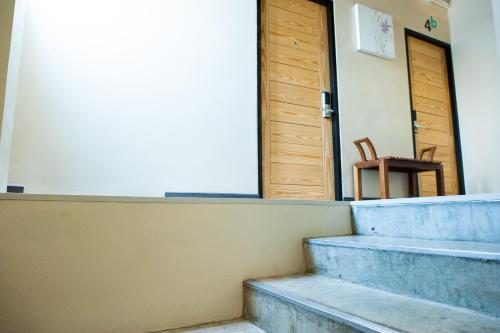 a set of stairs with a door and a chair at KENCOZY accommodation in Bangkok
