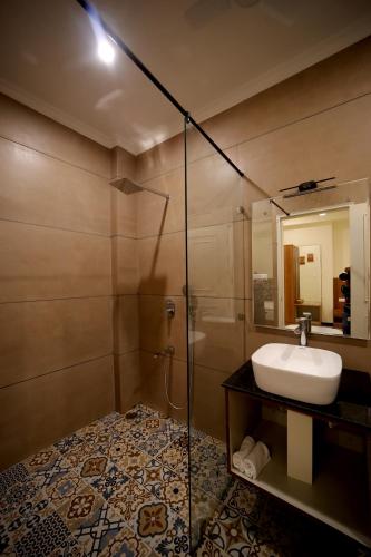 a bathroom with a sink and a shower at Arti's Homestay in Agra