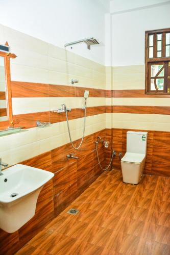 a bathroom with a sink and a toilet at Ocean Bliss Villa Mirissa in Kamburugamuwa