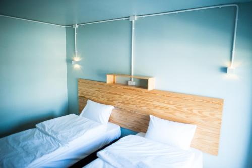 two beds in a room with blue walls at KENCOZY accommodation in Bangkok