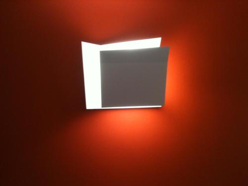 an open window on a red wall at L'Esperluette in Suze-la-Rousse