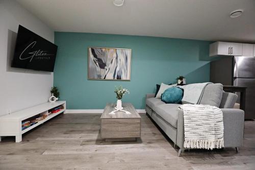 a living room with a couch and a table at Beautiful Suite King Bed,Long Stays,Disney,Airport in Edmonton