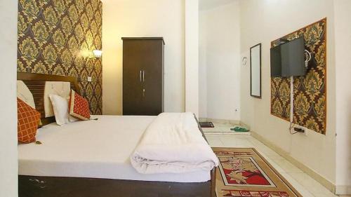 a bedroom with a bed and a tv on a wall at Nature Care Home stay in Chandīgarh