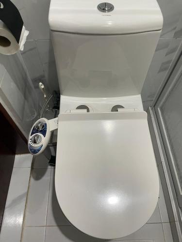 a bathroom with a white toilet in a room at Coastal Haven Resort in Siquijor