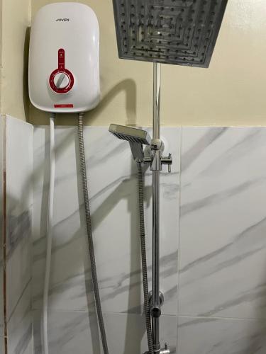 a white hair dryer sitting on a stand in a room at Coastal Haven Resort in Siquijor