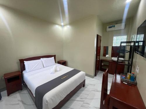a bedroom with a large bed and a bathroom at Coastal Haven Resort in Siquijor