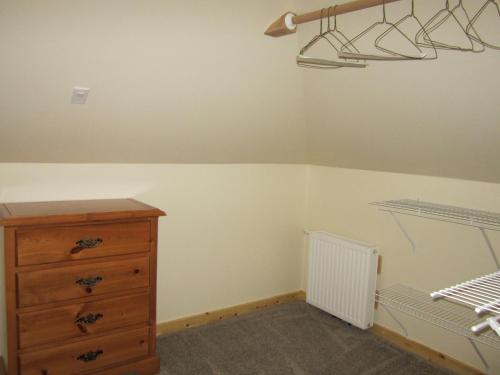 a bedroom with a bed and a dresser at Smithers Driftwood Lodge in Smithers
