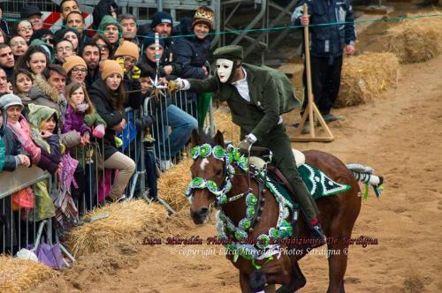 a man riding a horse in front of a crowd at Bed and Breakfast Su Niu in Quartucciu
