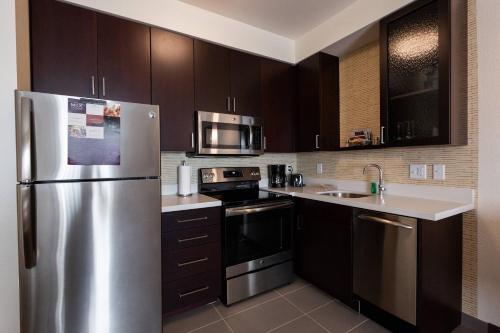 a kitchen with a stainless steel refrigerator at Residence Inn by Marriott Oklahoma City North/Quail Springs in Oklahoma City