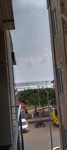 a view of the beach from a balcony of a building at AK Beach House in Velankanni