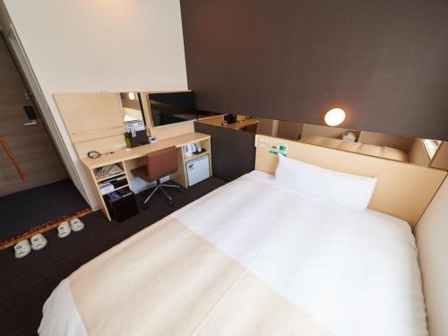 Postel nebo postele na pokoji v ubytování Super Hotel JR Nara Ekimae Sanjo Dori