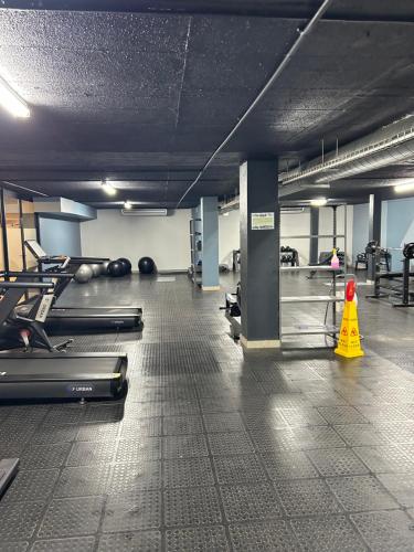 a gym with several treadmills and a yellow cone at Circa Apartment 86 in Pretoria