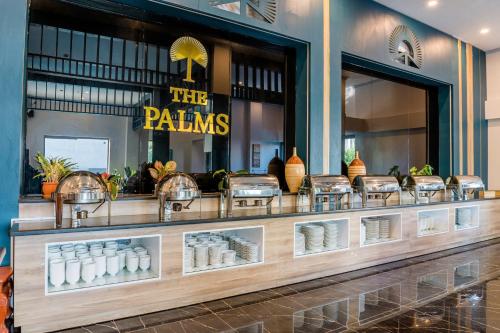 a store with a counter with a bunch of windows at The Palms Hotel Phan Thiết in Phan Thiet