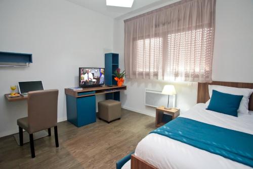 Ένα ή περισσότερα κρεβάτια σε δωμάτιο στο Appart Hotel Odalys City Tours Le Jardin des Lettres