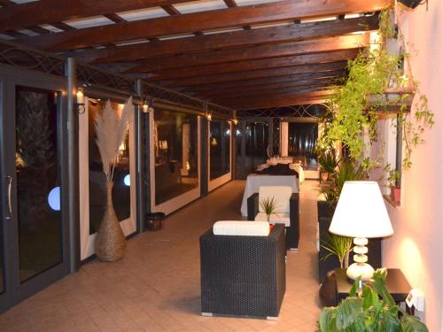 a patio with tables and chairs on a building at Queen Hotel in San Giovanni Teatino