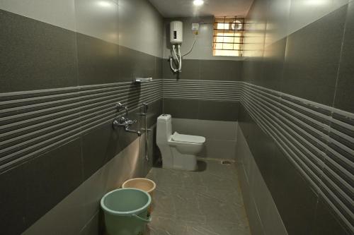 a bathroom with a toilet and a sink at Aarna Coastal Resort in Māvalli