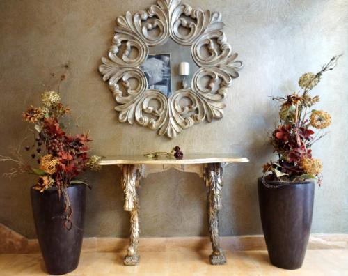 a mirror hanging on a wall with two potted plants at Don Agustin in San Luis de Sabinillas