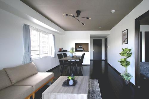 a living room with a couch and a table at Norwegian Wood 2 in Sapporo