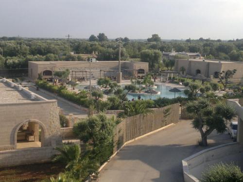 a view of a resort with a pool at Oasi Del Visir Resort in San Vito dei Normanni