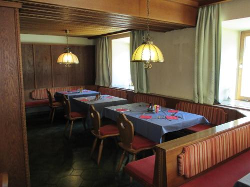 a dining room with two tables and chairs at Hotel Untermetzger in Zell am Ziller