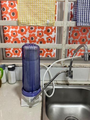 a blue blender sitting on top of a sink at AYAAN BLOSSOM BUDGET HOMESTAY FREE WiFi and Netflix in Tanah Rata