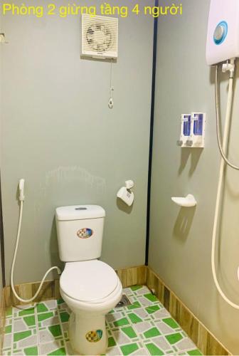 a bathroom with a toilet and a shower stall at The Lana Ho Tram Homestay in Xuyên Mộc