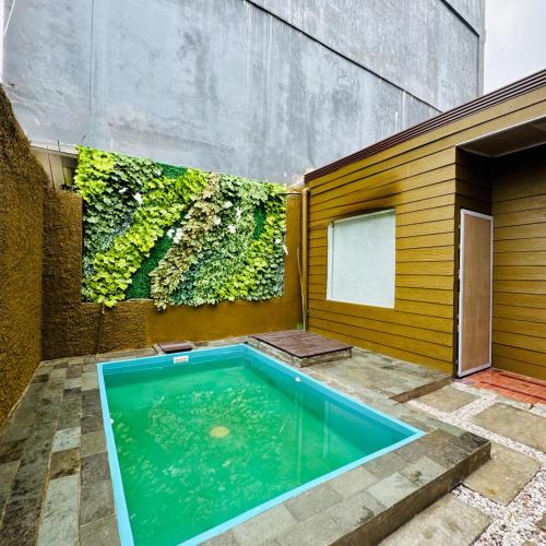 a swimming pool in the backyard of a house at Anugrah Inn in Nalagat