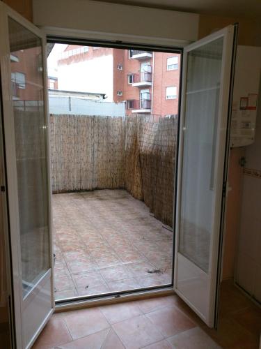 a sliding glass door in a room with a tile floor at San Roque 18 in Santo Domingo de la Calzada