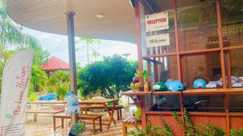 a restaurant with tables and a sign on the front of it at The Lana Ho Tram Homestay in Xuyên Mộc