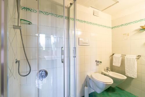 a bathroom with a shower and a toilet and a sink at Hotel Pescille Country House - Tuscany Charme in San Gimignano