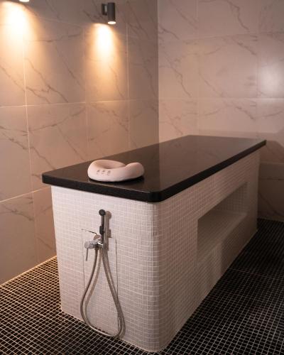 a bathroom with a sink and a shower at MIRAMAR Apart Hotel & SPA in Aktau