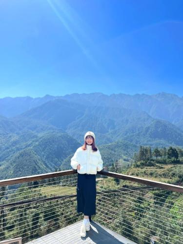 a woman standing on top of a mountain at Sapa Grand Blue Hotel in Sa Pa