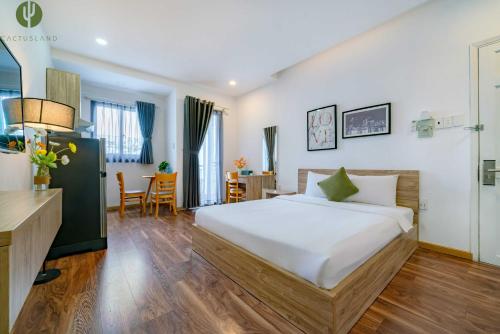 une chambre d'hôtel avec un lit et une salle à manger dans l'établissement Cactusland Hotel & Apartment, à Hô-Chi-Minh-Ville
