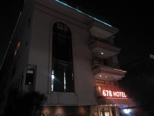a building with a sign on it at night at Hotel 678 Kemang Powered By Cocotel in Jakarta