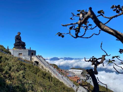 a view of the great wall and a statue on the mountain at Sapa Grand Blue Hotel in Sa Pa