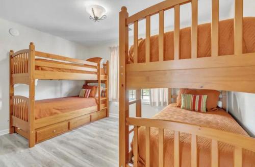 two wooden bunk beds in a room with at Whiskey River Lake Retreat in Taylorsville