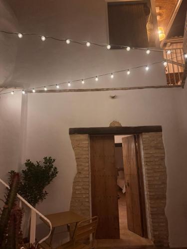 a room with a fireplace with lights on the wall at LAAN Arcos in Arcos de la Frontera