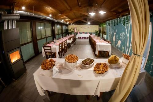 a large room with tables with food on them at Agriturismo Parco Campofelice in Lombardore