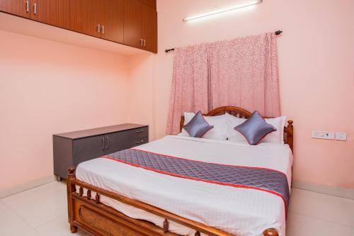 a bedroom with a bed and a window at HEAVEN PLEASANT STAy in Chennai