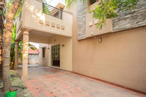 an empty courtyard of a house with a palm tree at HEAVEN PLEASANT STAy in Chennai