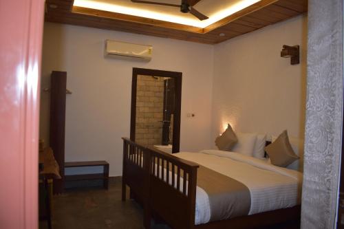 Postel nebo postele na pokoji v ubytování 3Acres Resorts Dehradun