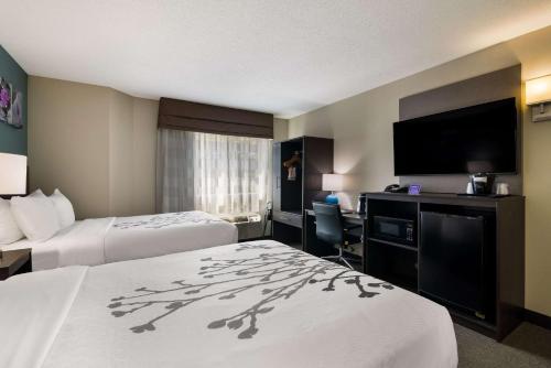 a hotel room with two beds and a flat screen tv at Garner Hotel Londonderry - Manchester by IHG in Londonderry