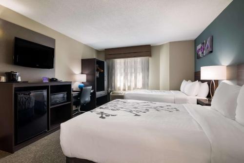a hotel room with two beds and a flat screen tv at Garner Hotel Londonderry - Manchester by IHG in Londonderry