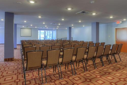 a room with a row of chairs and a screen at Quality Inn & Suites Chattanooga-East Ridge in Chattanooga