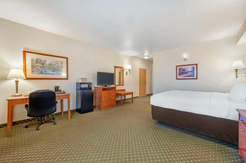 a large hotel room with a bed and a desk at Comfort Inn & Suites Rawlins in Rawlins
