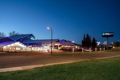 a building on the corner of a street at night at Clarion Pointe in Medicine Hat