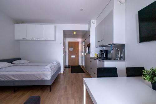 a small apartment with a bed and a kitchen at Prestigious Apartment & Enjoy Waterfront Living in Tampere