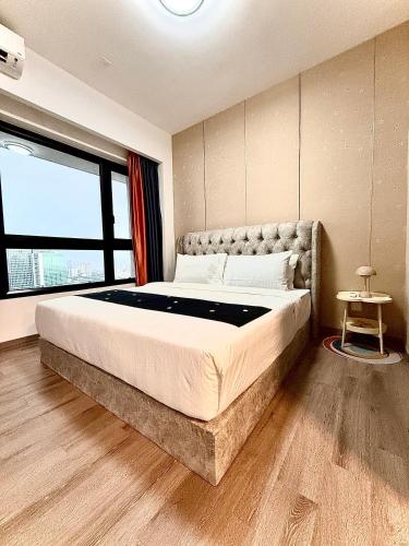 a bedroom with a large bed with a large window at Agile TRX Luxury suite Bukit bintang in Kuala Lumpur