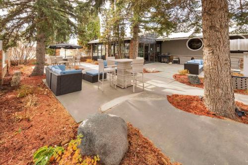 a patio with a table and chairs and trees at Clarion Pointe in Medicine Hat
