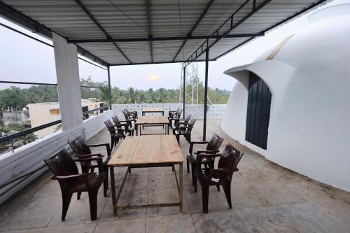 a row of tables and chairs on a balcony at JK Residency in Puducherry